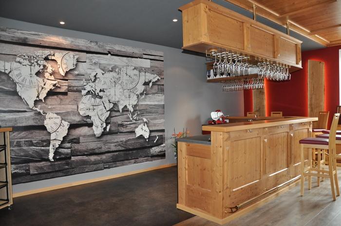 Holztheke in Ladeneinrichtung neben großem Bild von Weltkarte